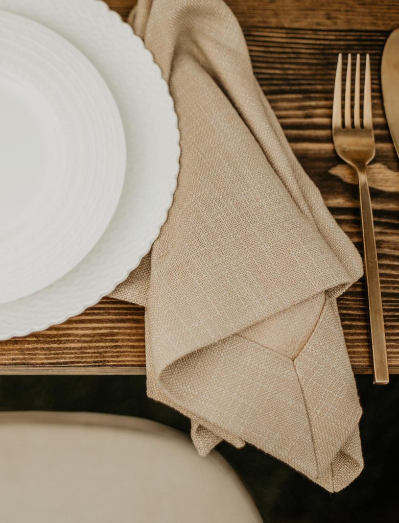 Tabletop with flatware and plates.